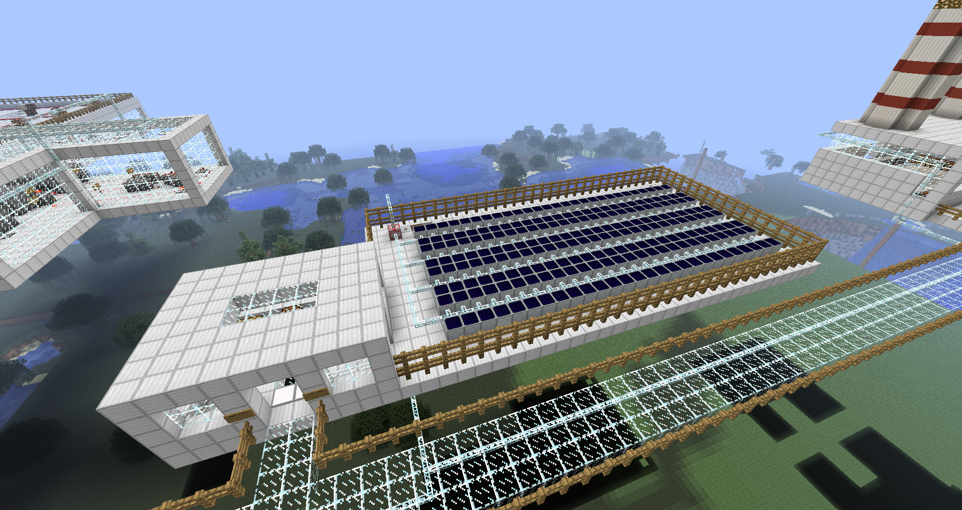 Overview of the solar plant showing several rows of solar cells feeding into the building.